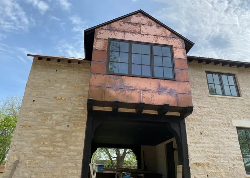Copper metal panel facade on a stone building for Metal Roof Coating in Eden